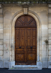 Beautiful old wooden door in a stone wall, close up