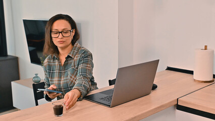 Businesswoman Working Remotely at Home Office with Laptop and Coffee