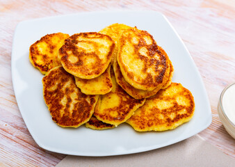 Tasty cheesecakes with sour cream on a plate. High quality photo