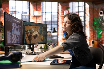 Worker in a creative office uses CAD software to design a house interior, provides a user interface...