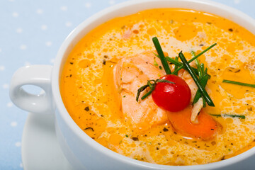 Traditional Norwegian cream salmon soup with carrots and potatoes