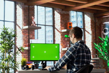 Person in home office analyzing data charts on mockup computer, interpreting statistical graphs, identifying trends. Freelancer using green screen PC, compiling analytical reports, processing data