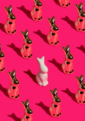 Pattern composition of Easter bunnies on hot pink background. Minimalist isometric concept.