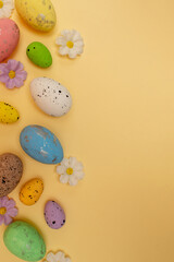 Easter composition made with colorful eggs on beige background. Creative minimal holiday concept.