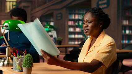 African american stressed scholar failing to comprehend and memorize lesson notes, struggling to...
