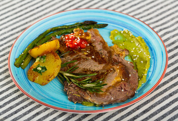 Veal with baked vegetables is tasty dish in the kitchen.