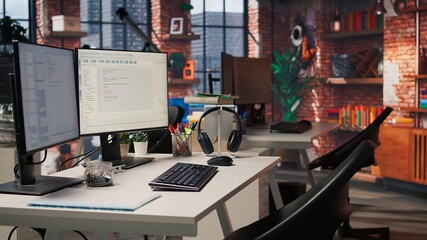 PC in startup office used to design and implement algorithms enabling machine learning. Technology...