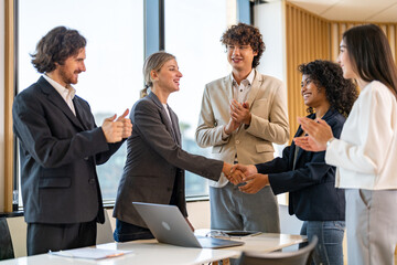 Multiracial team collaborating in modern office, diverse colleagues shaking hands during a business meeting, teamwork success, partnership agreement, professional collaboration multicultural workplace
