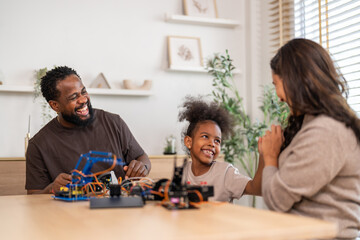African love family, father mother and daughter learning STEM education, science experiment, robotics toy, technology and innovation interactive learning, creativity and development at home