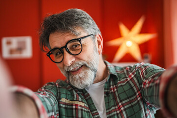 close up on mature man take self portrait smile and pose outdoor
