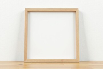 Obraz premium Simple square wooden frame against a stark white wall , shape, white, wood grain