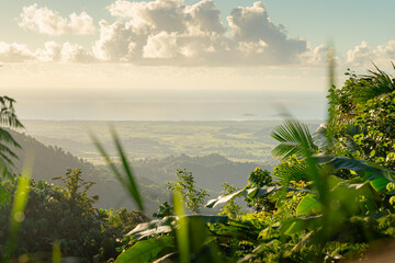 Scenic View of Lush Green Mountains and Valleys with the Ocean in the Background Under a Partly Cloudy Sky, Puerto Rico.