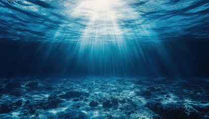 Sunlight beams penetrate the serene blue ocean, illuminating the underwater scene.