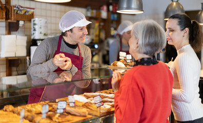Salesman offers bakery customers to buy fresh baked goods