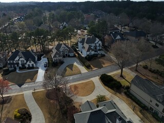 Beautiful aerial view of a sub division with golf course and a beautiful lake in suburbs of Atlanta during golden hour.
