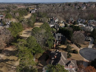 Beautiful aerial view of a sub division with golf course and a beautiful lake in suburbs of Atlanta during golden hour.