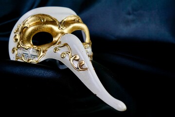 Venetian doctor mask on a black background, concept of history, plague, carnival, mystery