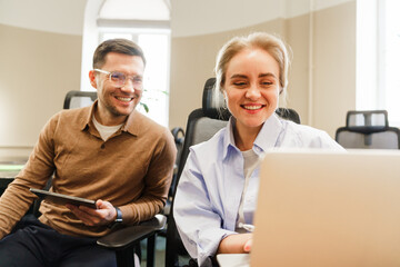 Two professionals working together in a modern office setting during a collaborative session