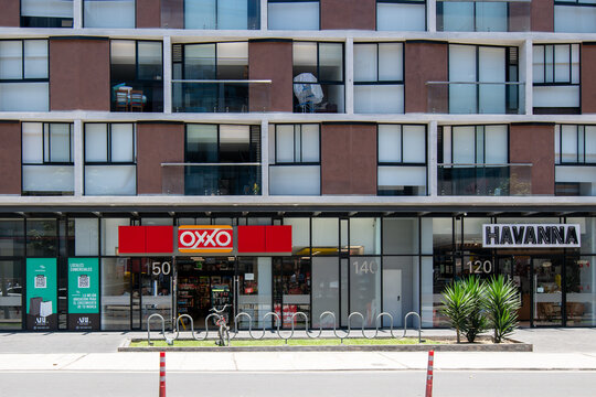 OXXO convenience Store next to Havanna store on street level of a mixed use building in San Isidro, Lima, Peru
