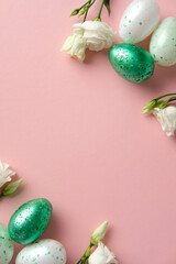 Easter flat lay composition. Top view green and white speckled eggs with white flowers on a pink background