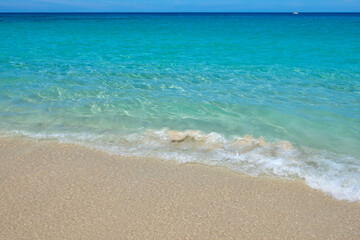 Idyllic Hawaiian Coastline: Crystal Clear Turquoise Water Lapping at a Sandy Beach
