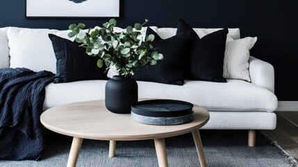 Modern living room with white sofa, round wooden coffee table, and patterned rug