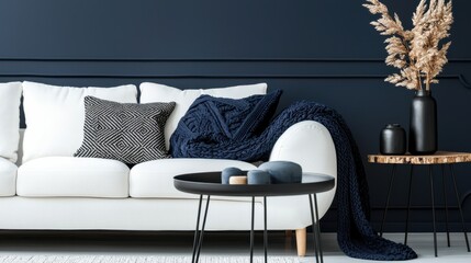 Modern living room with white sofa, navy blue accents, and decorative elements
