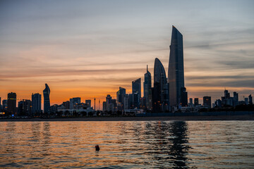 Fototapeta premium Kuwait City Skyline at Sunset with Reflections on the Arabian Gulf