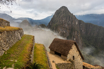 Early morning misty view of Machu Picchu ruins, Peru