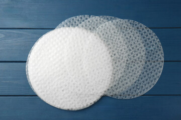 Edible rice paper sheets on blue wooden table, flat lay