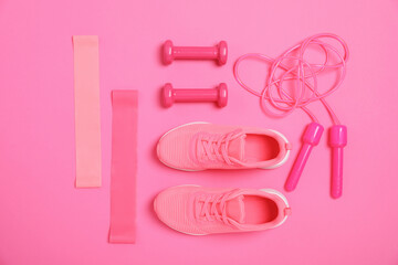 Different sports equipment and sneakers on bright pink background, flat lay