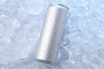 Refreshing drink in can on ice cubes, top view