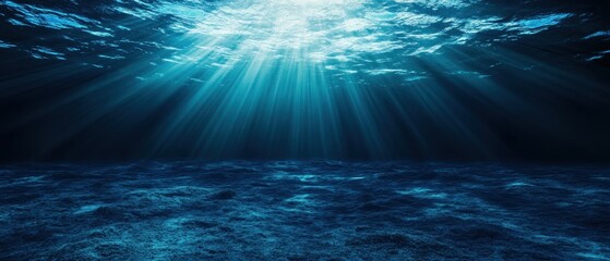 Sunlight beams penetrate the deep blue ocean, creating a tranquil underwater scene.
