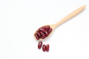 Red beans in spoon on white background 