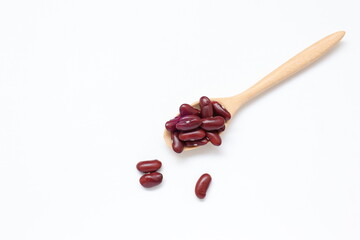 Red kidney beans in spoon isolated on white background 
