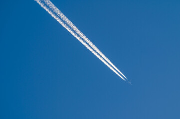 Aircraft and contrail in blue sky over Australia