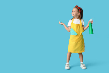 Cute little happy girl with bottle of detergent and rag on blue background