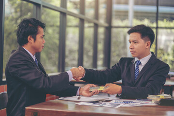 Businessman handshake at business meeting after negotiations with business partners and making investment. Selected focus