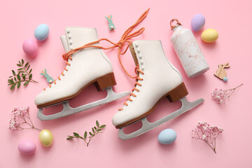 Composition with ice skates, bottle of water and Easter eggs on pink background © Pixel-Shot