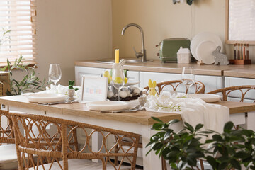 Dining table set for Easter with flowers in kitchen