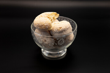 A glass bowl filled with cinnamon sugar cake donuts showcases their golden-brown, sugary coating. The soft, fluffy texture and warm, comforting aroma make these treats irresistible.