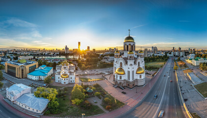 Fototapeta premium Summer Yekaterinburg, Temple on Blood and Church of St Nicholas in sunset. Aerial view of Yekaterinburg, Russia. Translation of text on the temple: Honest to the Lord is the death of His saints