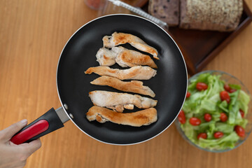 Perfectly fried golden-brown chicken strips, expertly cooked to crispy perfection, paired with a fresh, vibrant tomato salad that adds a burst of flavor, offering a delightful gourmet twist on a class