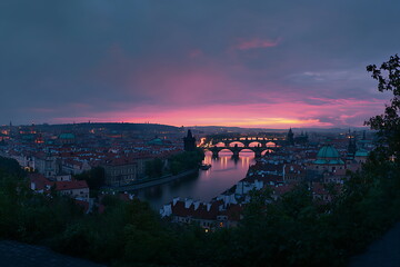 Prague cityscape with river and bridges at blue