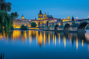 Fototapeta premium Prague cityscape with river and bridges at blue