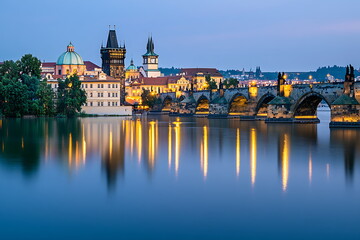 Naklejka premium Prague cityscape with river and bridges at blue