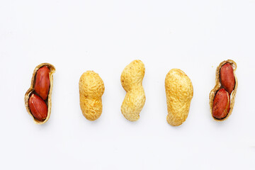 Roasted peanuts in shell on white background.