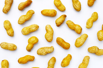 Roasted peanuts in shell on white background.