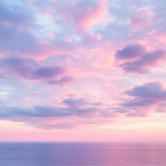 Obraz premium Pastel pink and purple sunset over a calm ocean. Soft, dreamy clouds fill the sky, creating a serene and peaceful atmosphere.