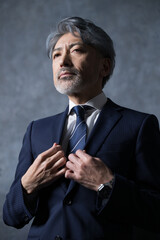 Gray-haired businessman with a tie heading for a business meeting. Executive image of enthusiasm...